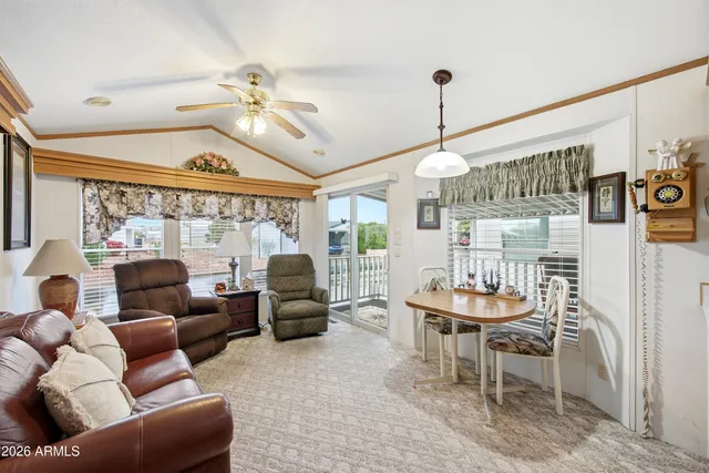 a living room with furniture a chandelier and a large window