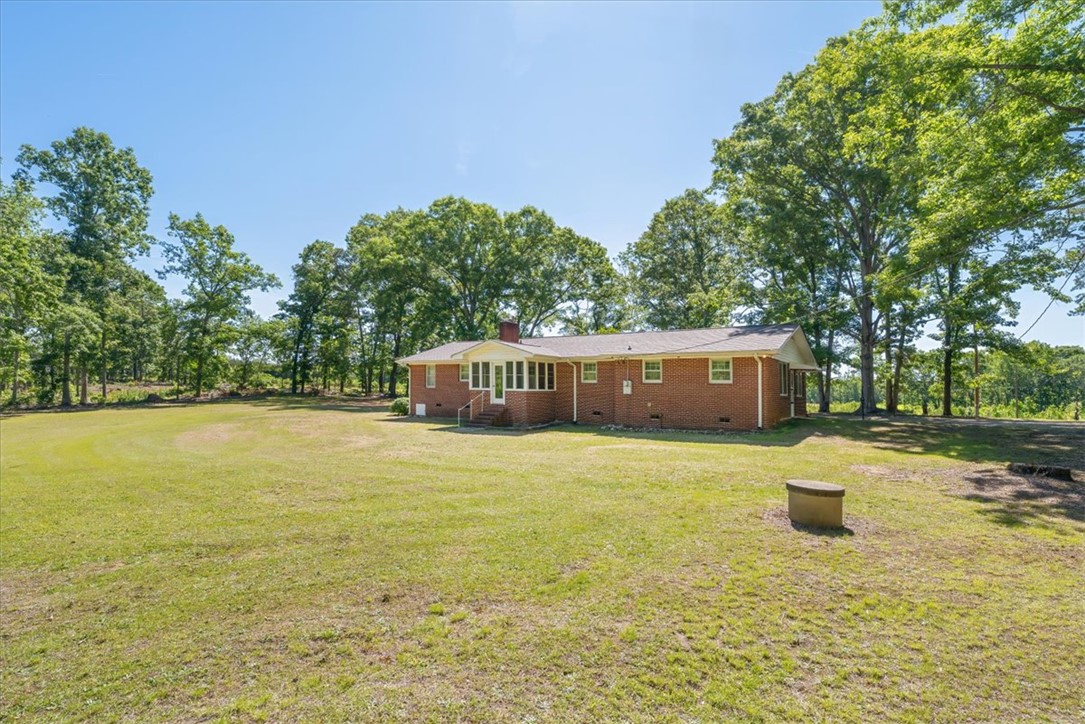304 Shaw Road Honea Path, SC 29654 - Photo 32 of 39 This spacious property features a charming brick residence amidst a vast, verdant lawn.
