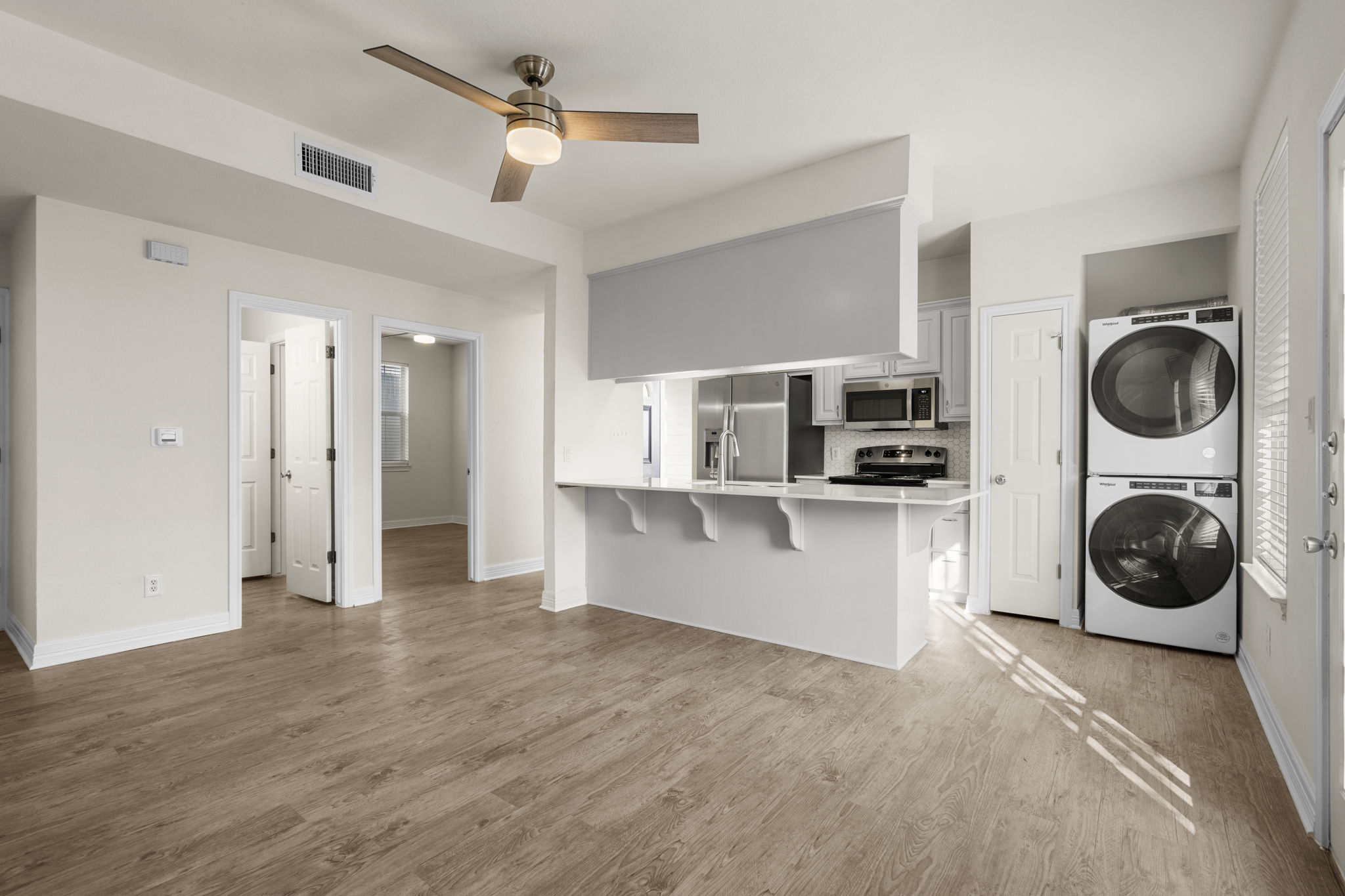 a view of a kitchen with refrigerator and cabinets