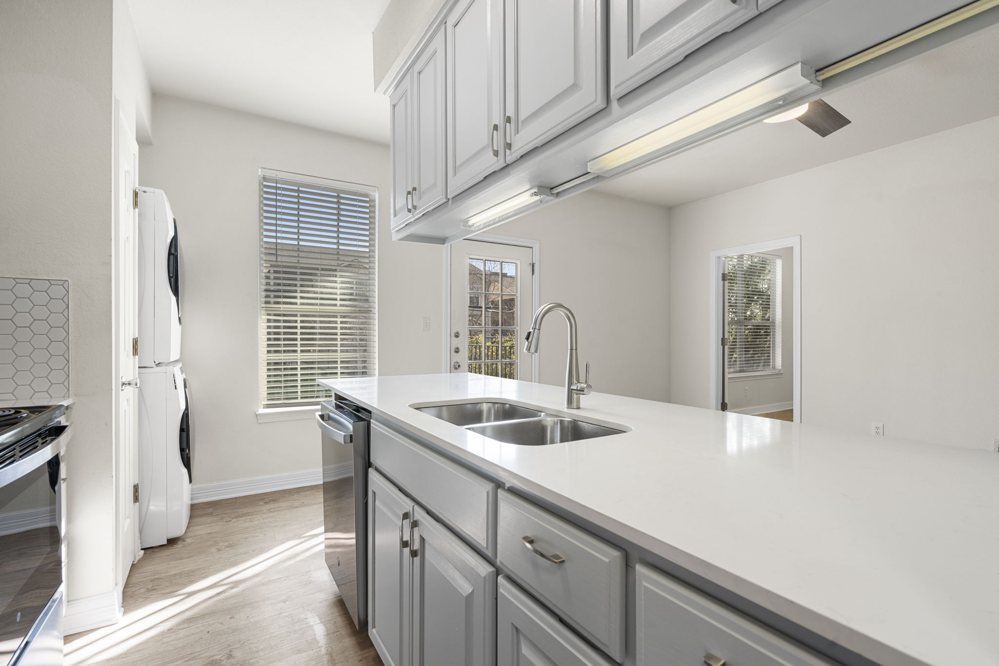 1100 West 25th Street, Unit 101 Austin, TX 78705 - Photo 21 of 39 a kitchen with a sink and a window
