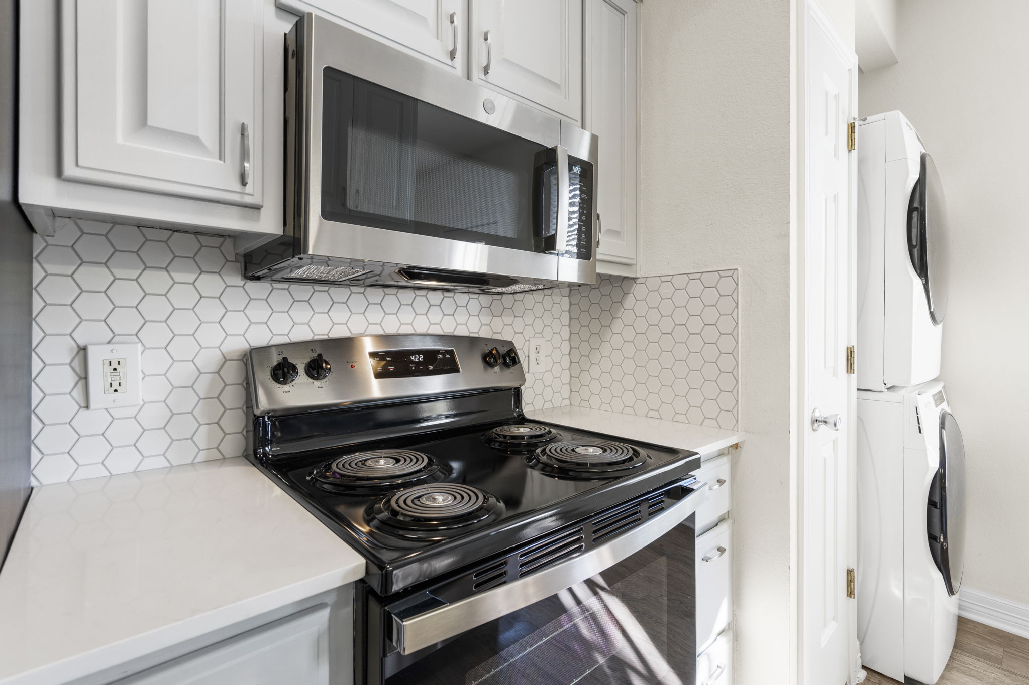1100 West 25th Street, Unit 101 Austin, TX 78705 - Photo 22 of 39 a kitchen with a stove and a microwave