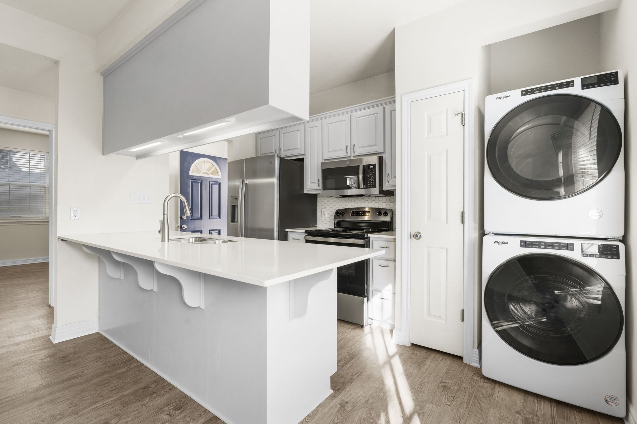 1100 West 25th Street, Unit 101 Austin, TX 78705 - Photo 24 of 39 a kitchen with a sink and a washer dryer