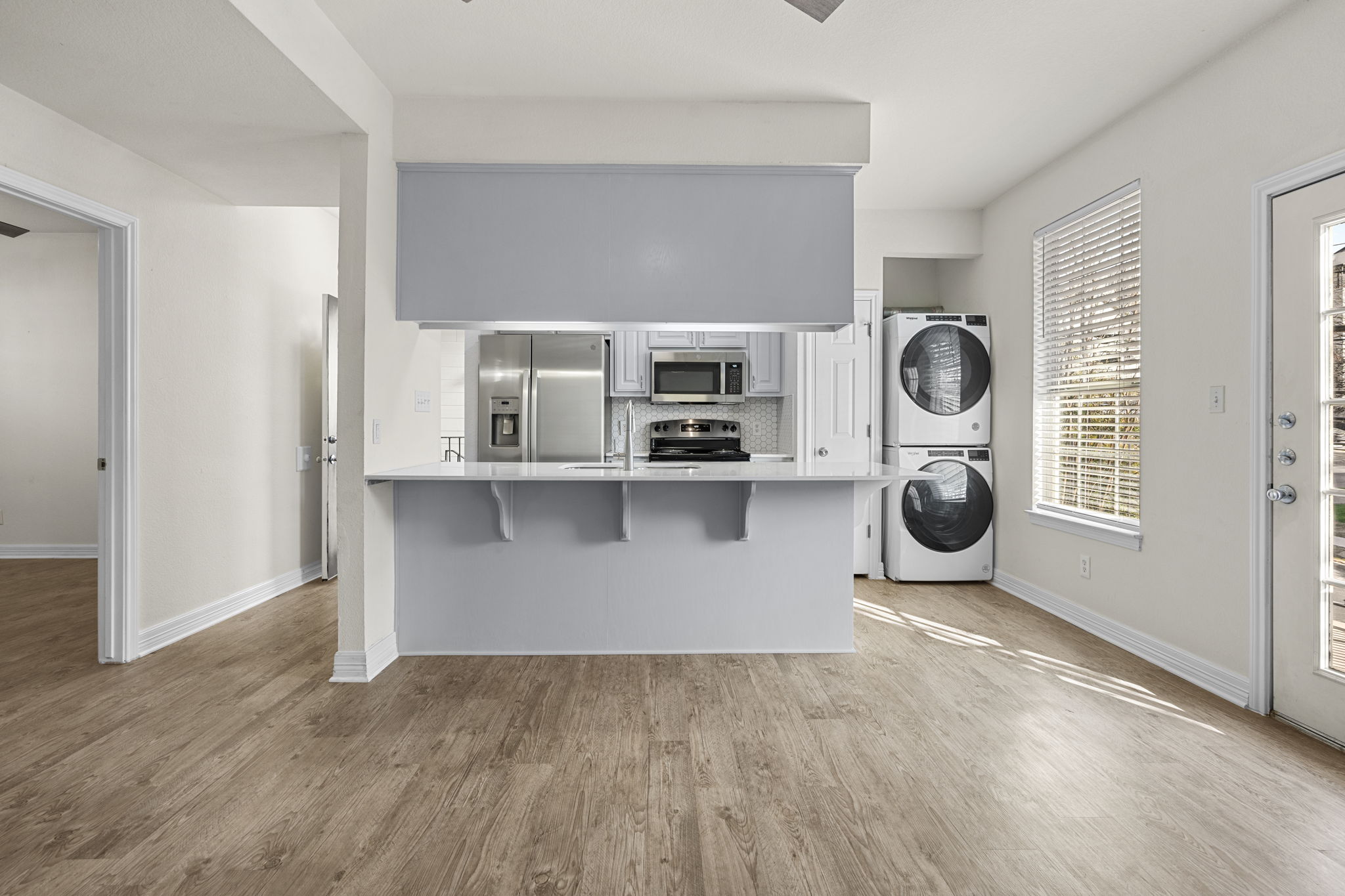 1100 West 25th Street, Unit 101 Austin, TX 78705 - Photo 26 of 39 a view of kitchen with stainless steel appliances wooden floor and a window