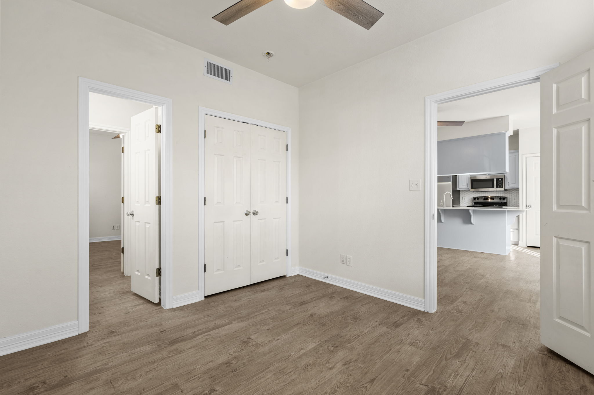 1100 West 25th Street, Unit 101 Austin, TX 78705 - Photo 29 of 39 an empty room with wooden floor cabinet and windows