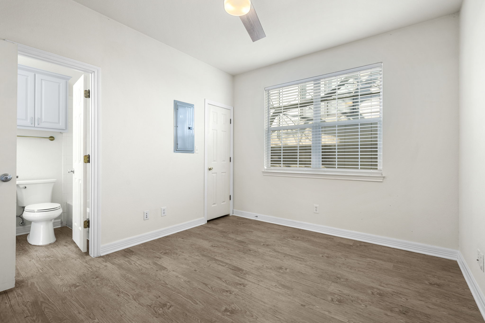 1100 West 25th Street, Unit 101 Austin, TX 78705 - Photo 39 of 39 a view of a room with wooden floor and a window