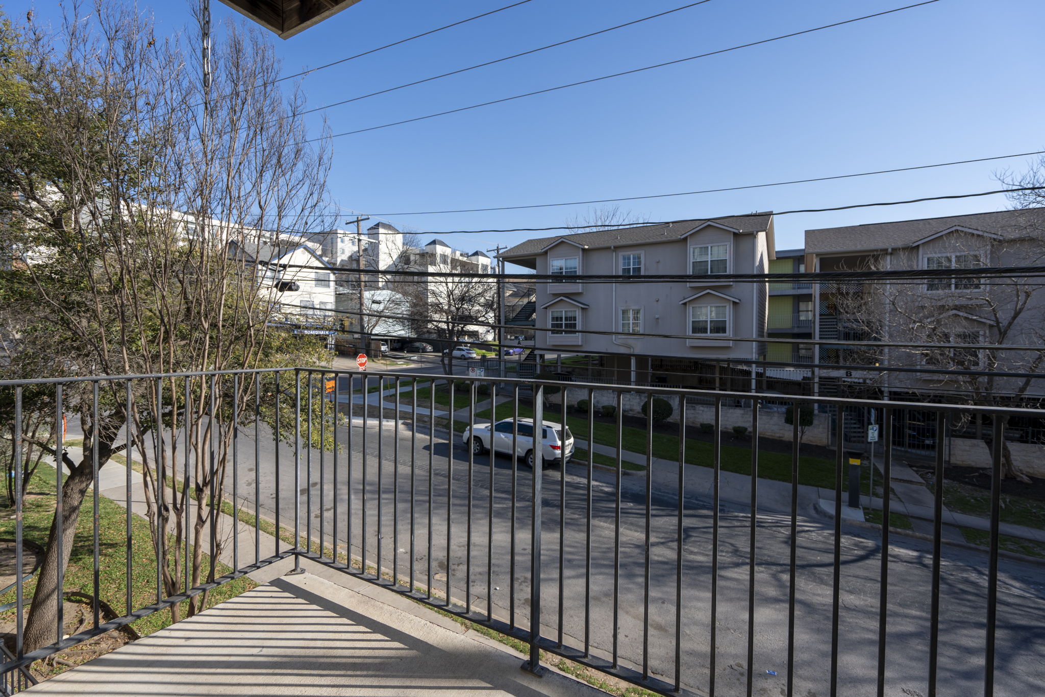 1100 West 25th Street, Unit 101 Austin, TX 78705 - Photo 6 of 39 a view of a balcony with wooden floor