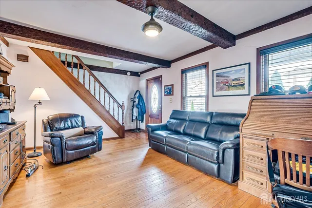 a living room with furniture and a book shelf