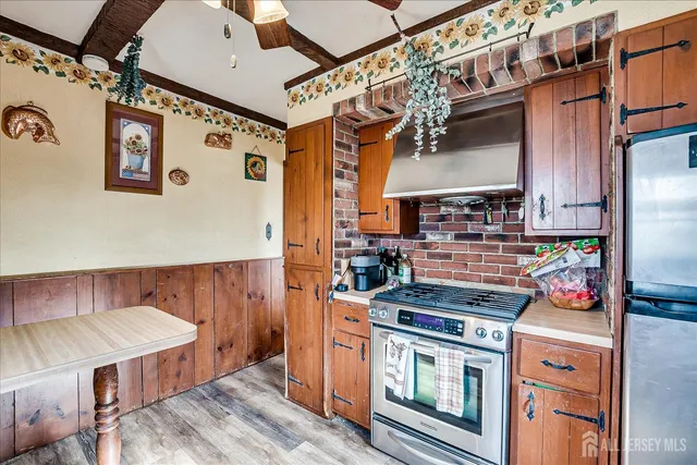 a kitchen with stainless steel appliances granite countertop a stove and a refrigerator