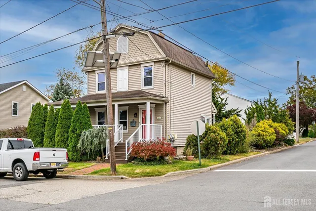 a front view of a house with a garden and plants