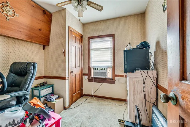 a bedroom with furniture and a window