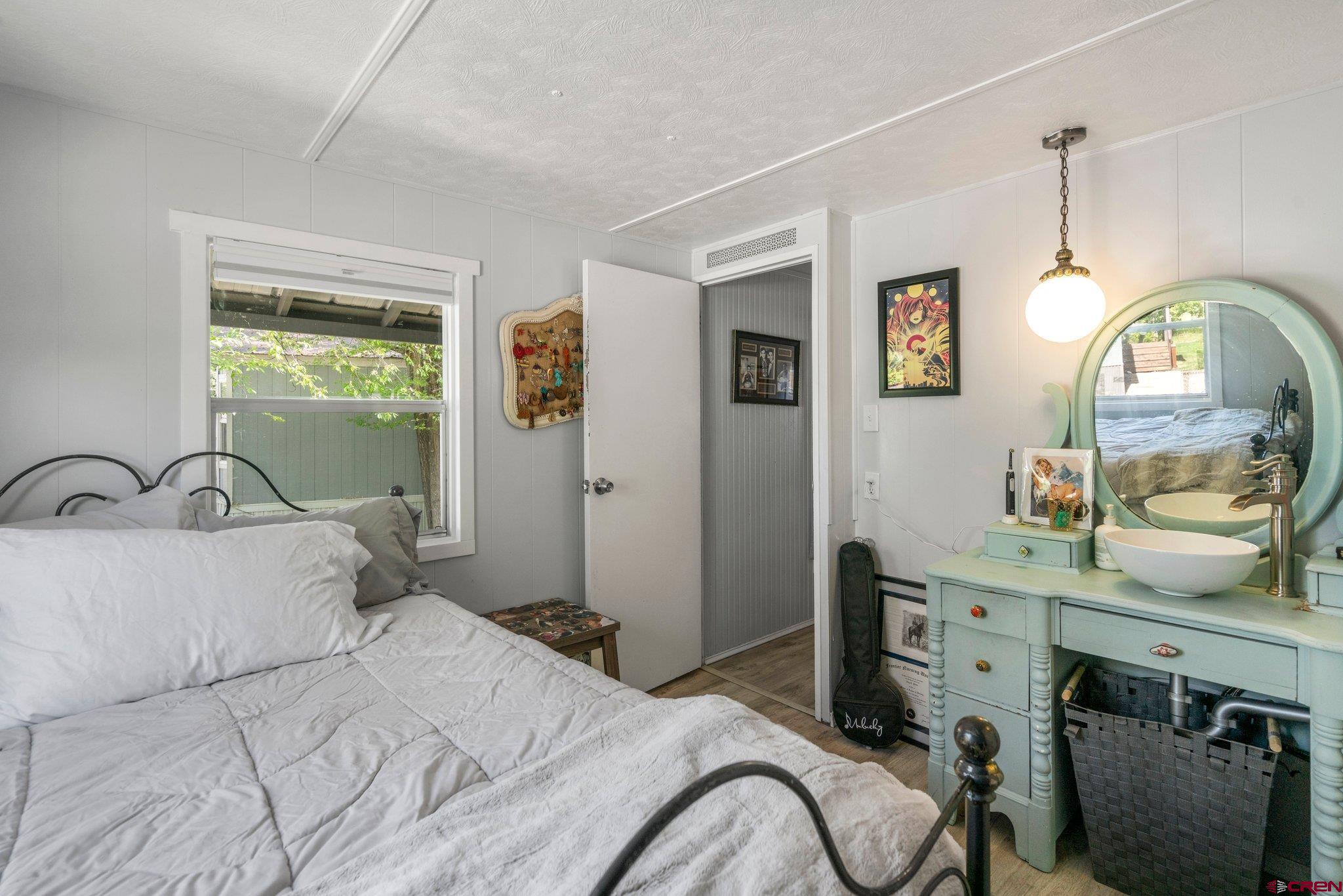 485 Florida Road, Unit D6 Durango, CO 81301 - Photo 13 of 35 a bedroom with a bed a mirror and a window