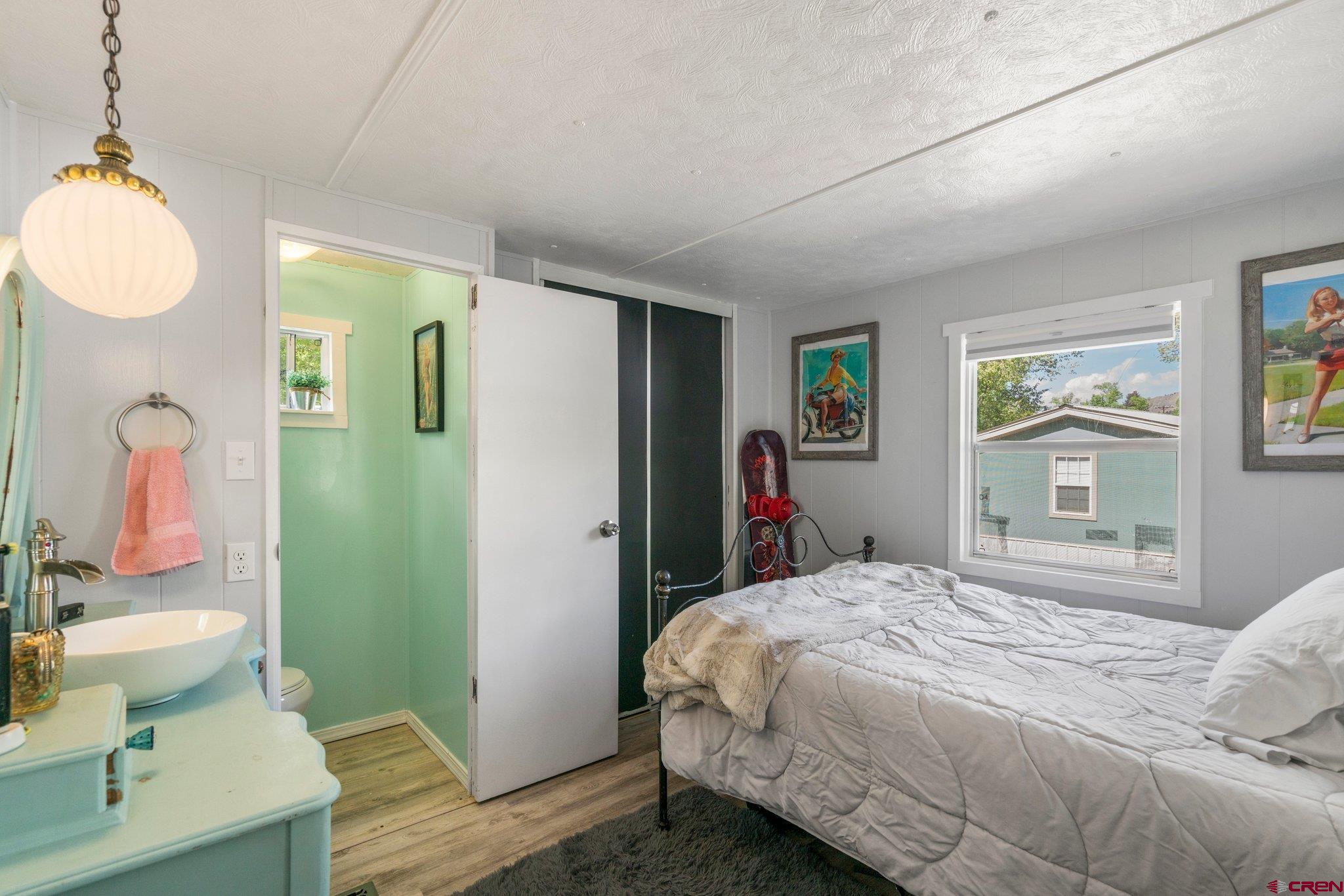 485 Florida Road, Unit D6 Durango, CO 81301 - Photo 14 of 35 a bedroom with a bed and dresser with wooden floor