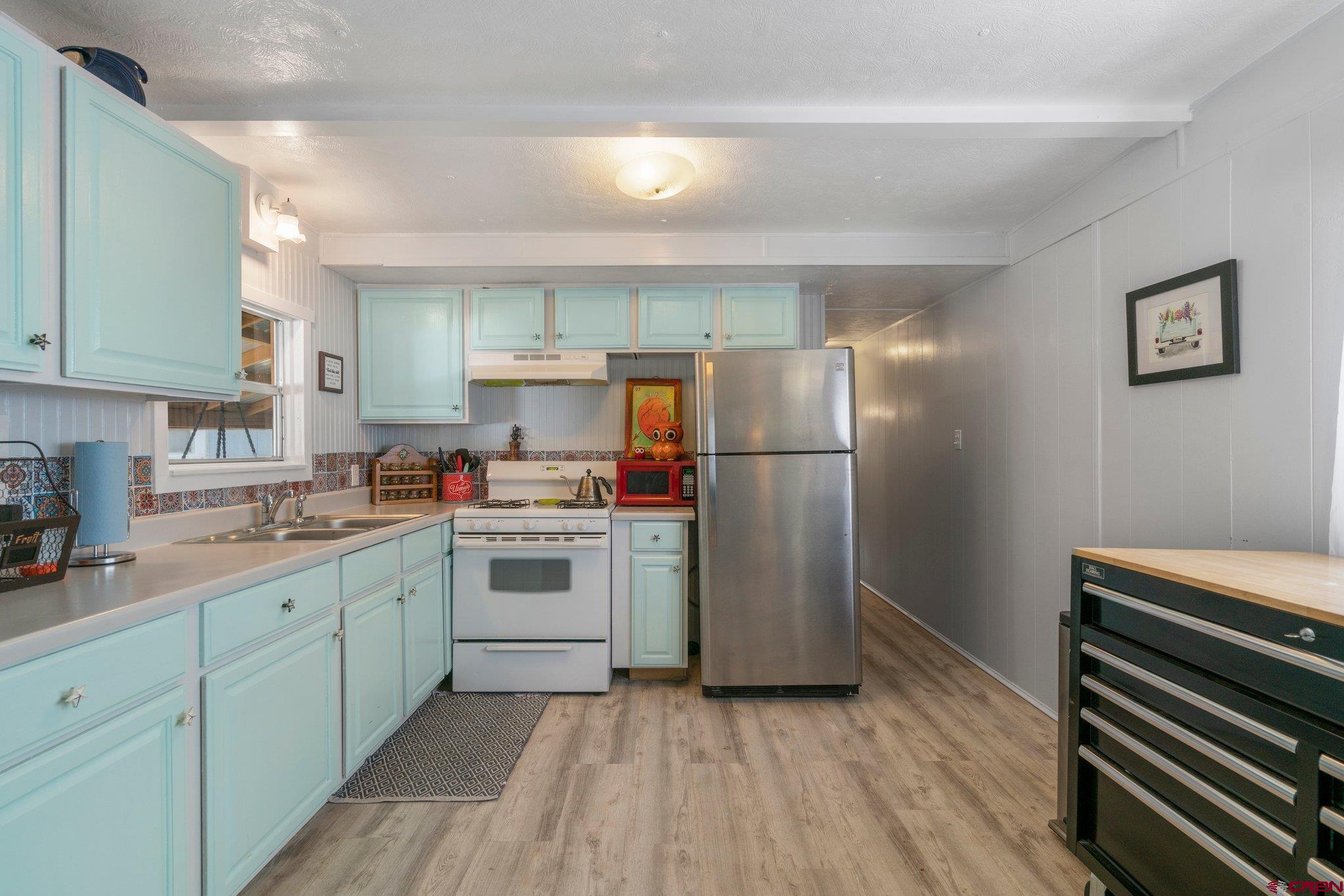 485 Florida Road, Unit D6 Durango, CO 81301 - Photo 5 of 35 a kitchen with a refrigerator sink and cabinets