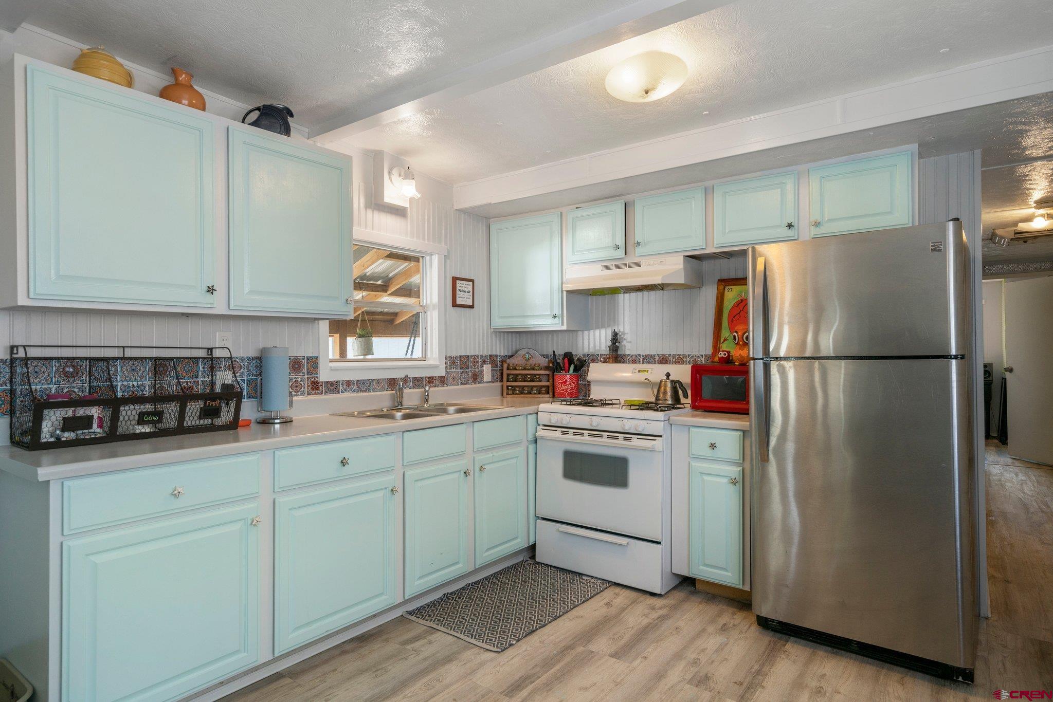 485 Florida Road, Unit D6 Durango, CO 81301 - Photo 6 of 35 a kitchen with stainless steel appliances granite countertop a refrigerator sink and cabinets