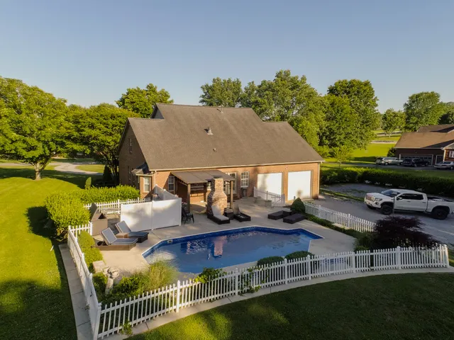 a view of house with a yard
