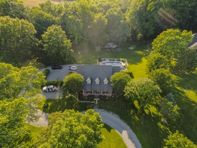 a kitchen with a sink a counter and chairs