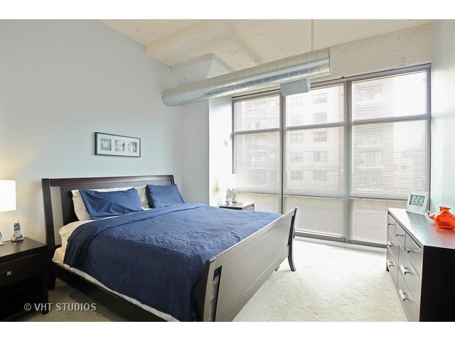1530 South State Street, Unit 612 Chicago, IL 60605 - Photo 11 of 25 a bedroom with a bed and a large window