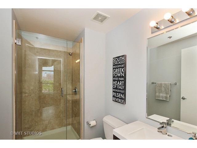 1530 South State Street, Unit 612 Chicago, IL 60605 - Photo 16 of 25 a bathroom with a sink mirror and a shower
