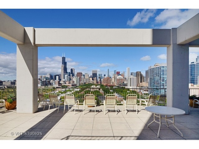 1530 South State Street, Unit 612 Chicago, IL 60605 - Photo 20 of 25 a view of a rooftop deck with dining table and chairs