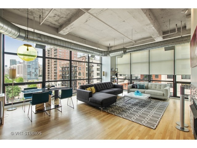 1530 South State Street, Unit 612 Chicago, IL 60605 - Photo 5 of 25 a living room with lots of furniture and a large window