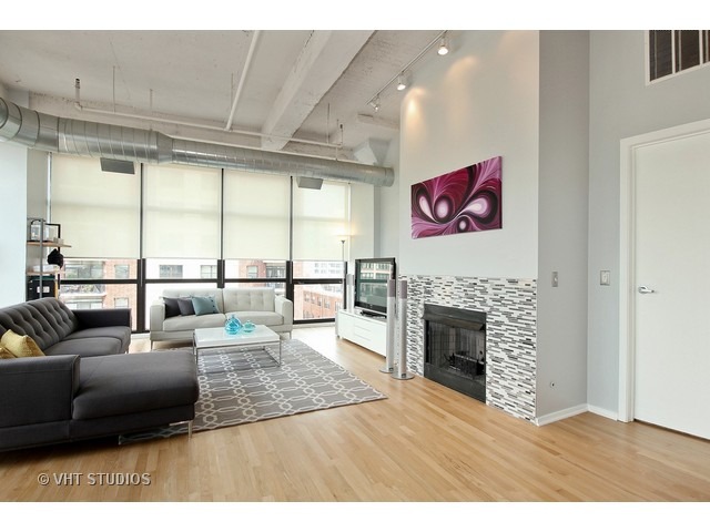 1530 South State Street, Unit 612 Chicago, IL 60605 - Photo 6 of 25 a living room with furniture large window and a fireplace