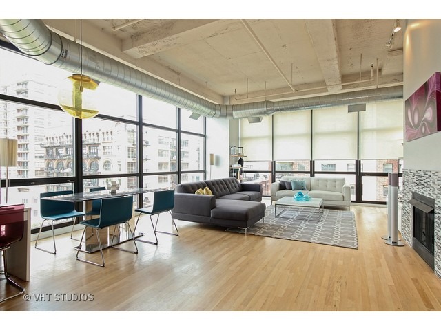 1530 South State Street, Unit 612 Chicago, IL 60605 - Photo 7 of 25 a living room with furniture large windows and wooden floor