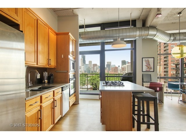 1530 South State Street, Unit 612 Chicago, IL 60605 - Photo 8 of 25 a kitchen with kitchen island a large window in it