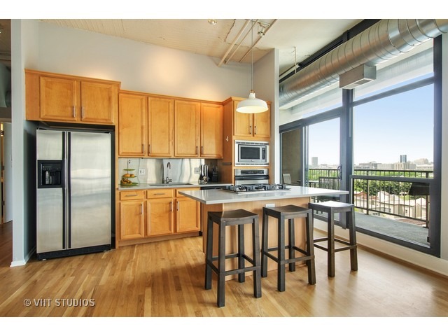 1530 South State Street, Unit 612 Chicago, IL 60605 - Photo 9 of 25 a open kitchen with stainless steel appliances granite countertop a stove top oven a sink and dining table with granite countertops
