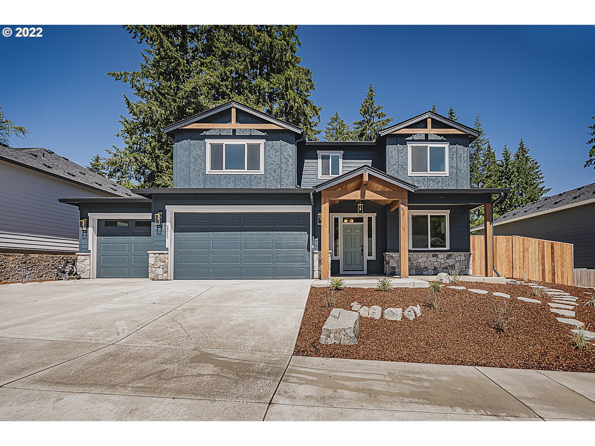 2217 South Royal Court Ridgefield, WA 98642 - Photo 1 of 26 a front view of a house with a yard
