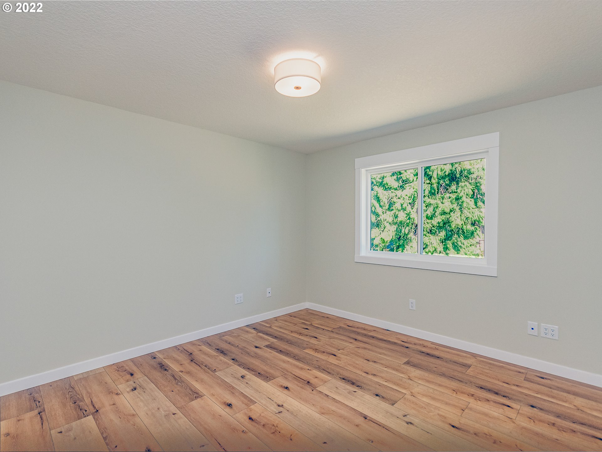 2217 South Royal Court Ridgefield, WA 98642 - Photo 19 of 26 an empty room with wooden floor and windows