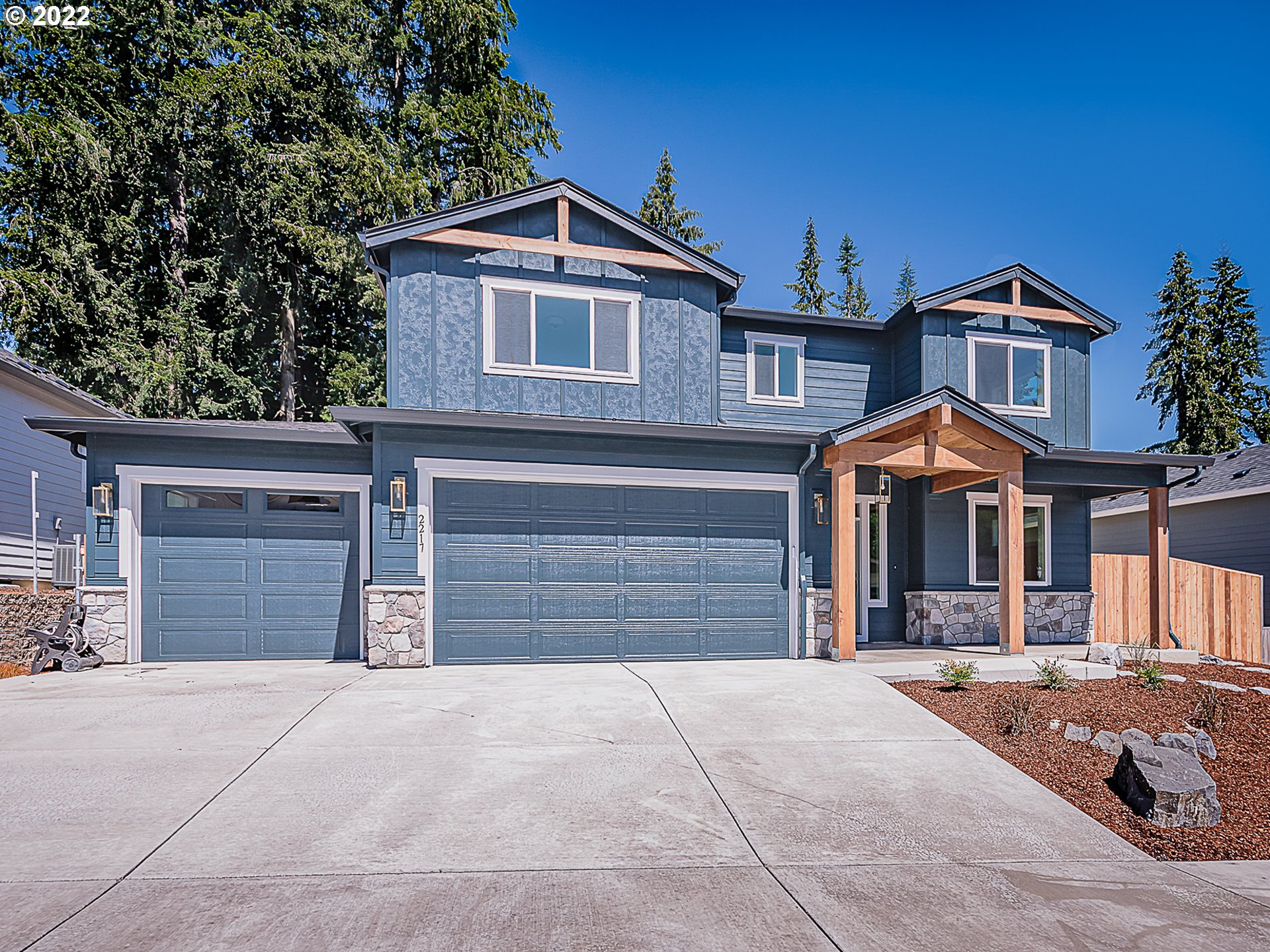 2217 South Royal Court Ridgefield, WA 98642 - Photo 2 of 26 a front view of a house with a yard and garage