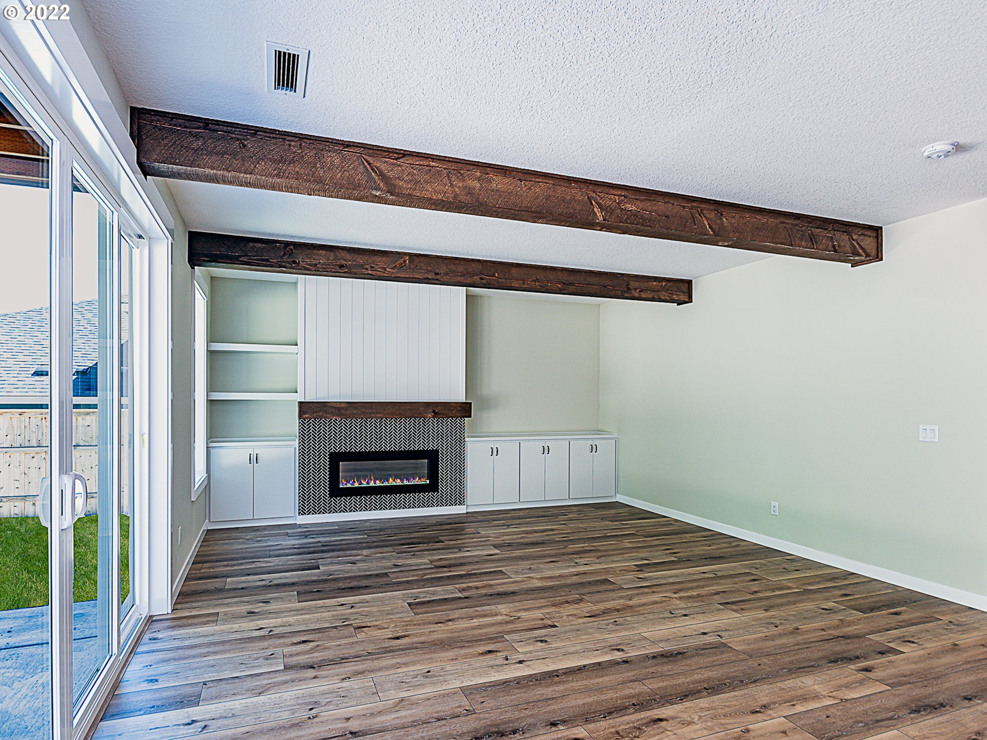 2217 South Royal Court Ridgefield, WA 98642 - Photo 3 of 26 a view of empty room with wooden floor and fireplace