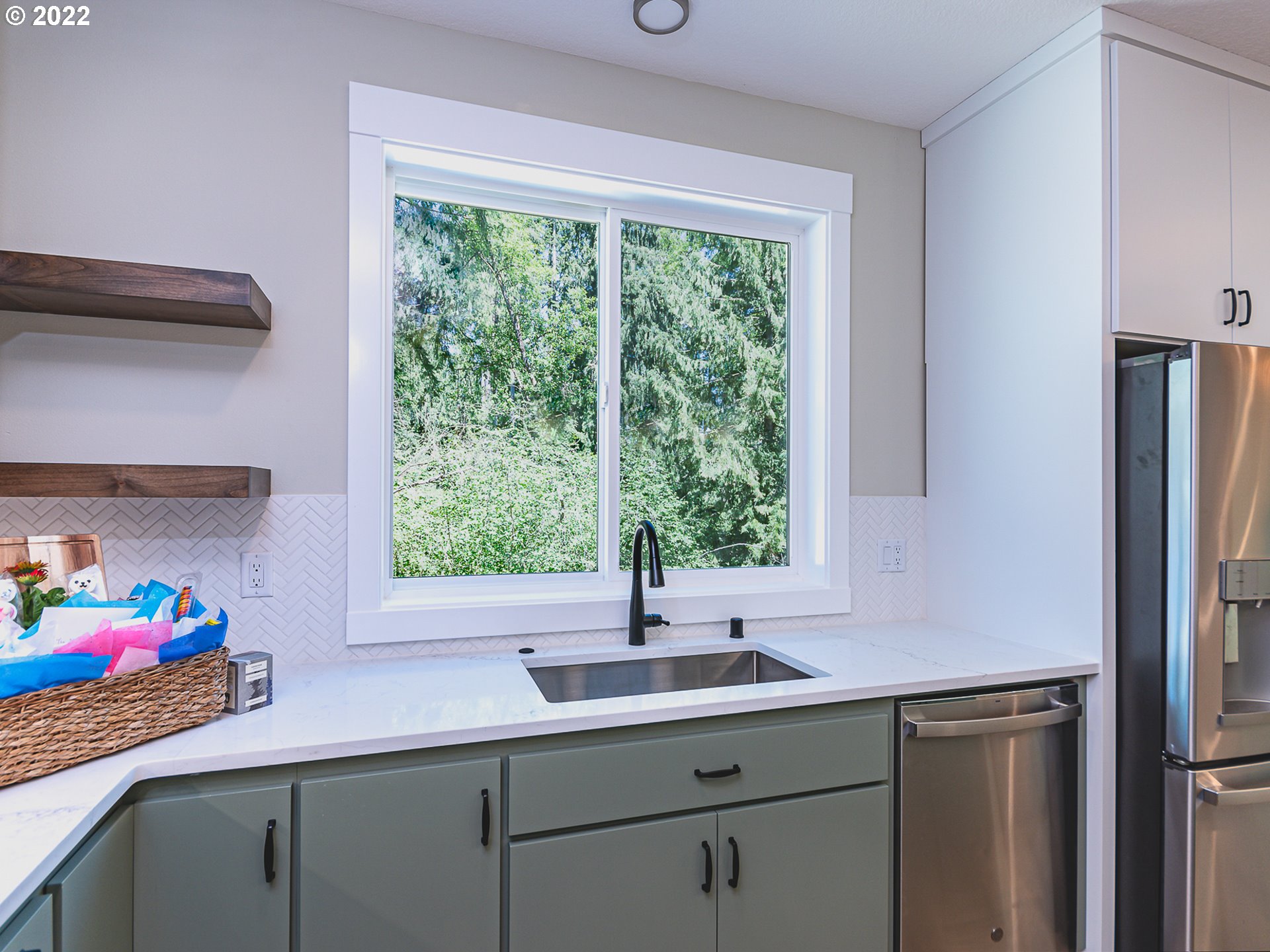 2217 South Royal Court Ridgefield, WA 98642 - Photo 6 of 26 a kitchen with a sink cabinets and a large window