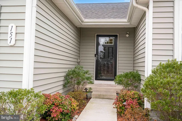 a front view of a house with a flower garden