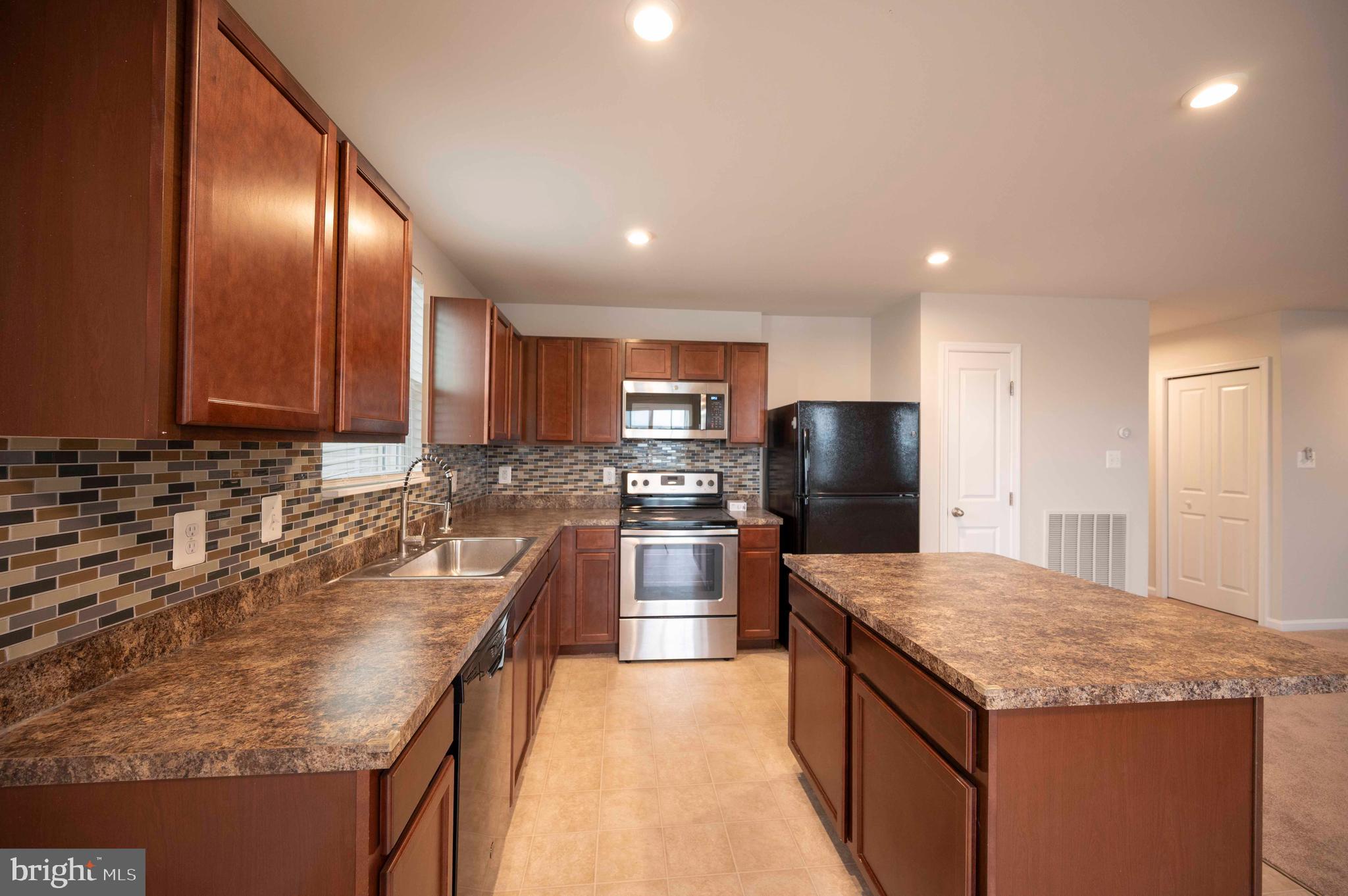 151 Cougill Road Middletown, VA 22645 - Photo 19 of 41 a kitchen with stainless steel appliances granite countertop granite counter tops and a refrigerator