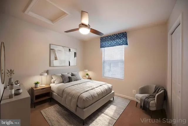 a spacious bedroom with a bed a mirror on dresser and a chandelier