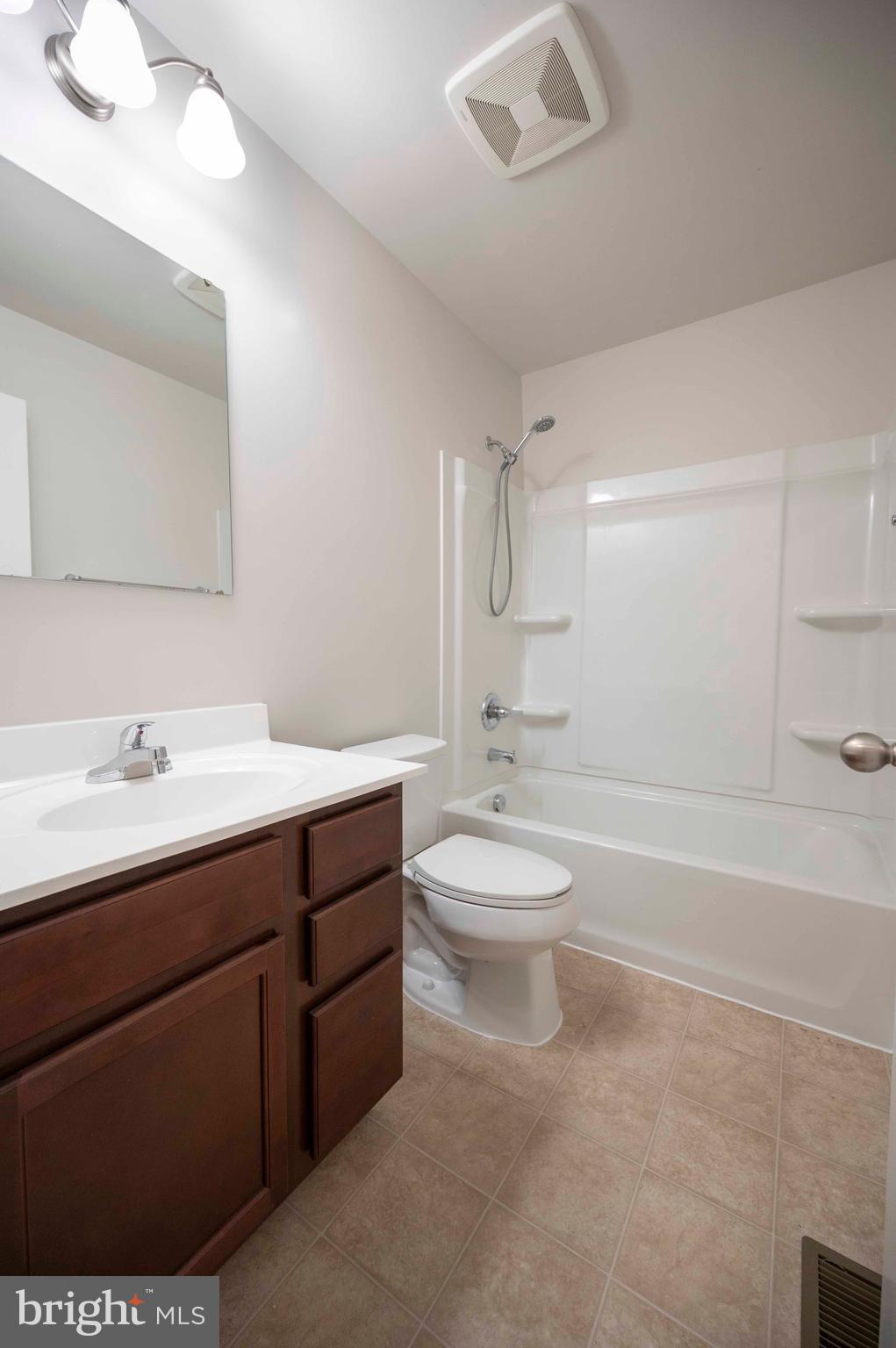 151 Cougill Road Middletown, VA 22645 - Photo 31 of 41 a bathroom with a toilet a sink a mirror and a bathtub