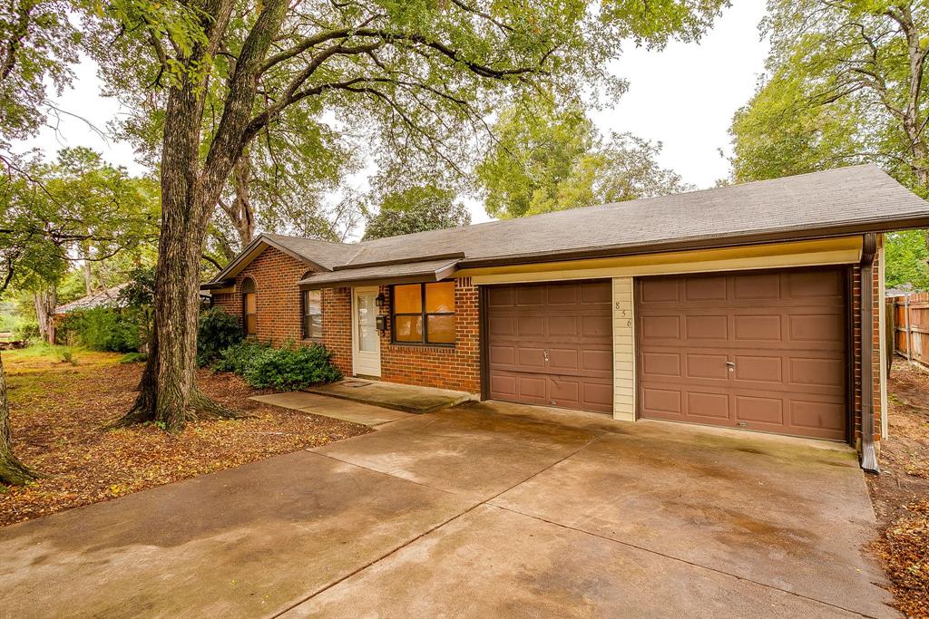 856 Broadway Avenue Euless, TX 76040 - Photo 1 of 35 a front view of a house with a yard and garage