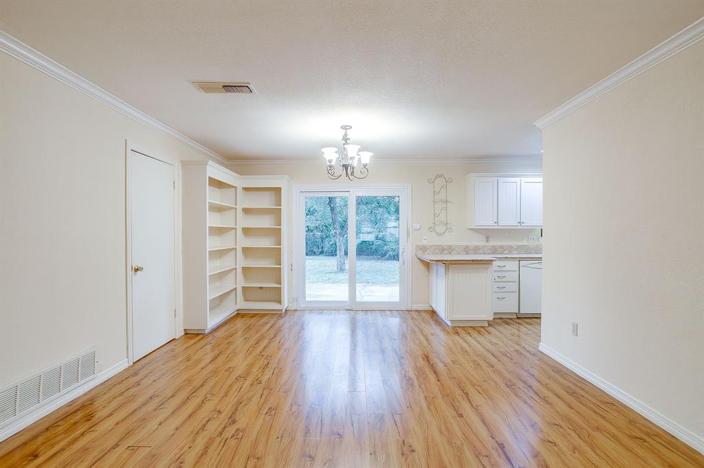 856 Broadway Avenue Euless, TX 76040 - Photo 11 of 35 a view of a room with wooden floor closet and windows