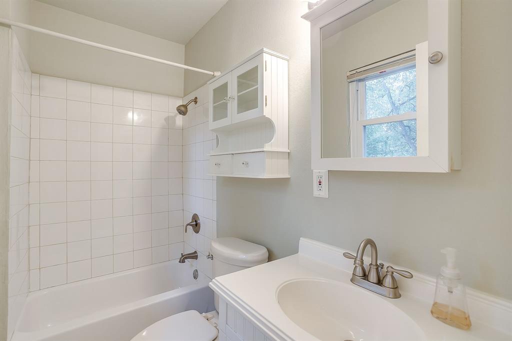 856 Broadway Avenue Euless, TX 76040 - Photo 21 of 35 a bathroom with a sink toilet and shower