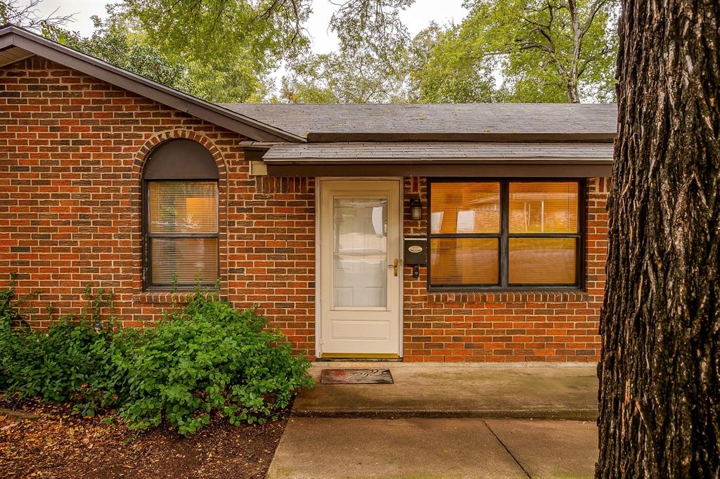 856 Broadway Avenue Euless, TX 76040 - Photo 3 of 35 a front view of a house with large windows