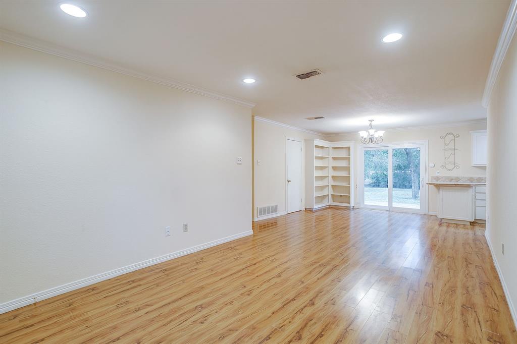 856 Broadway Avenue Euless, TX 76040 - Photo 7 of 35 a view of an empty room with wooden floor and a window