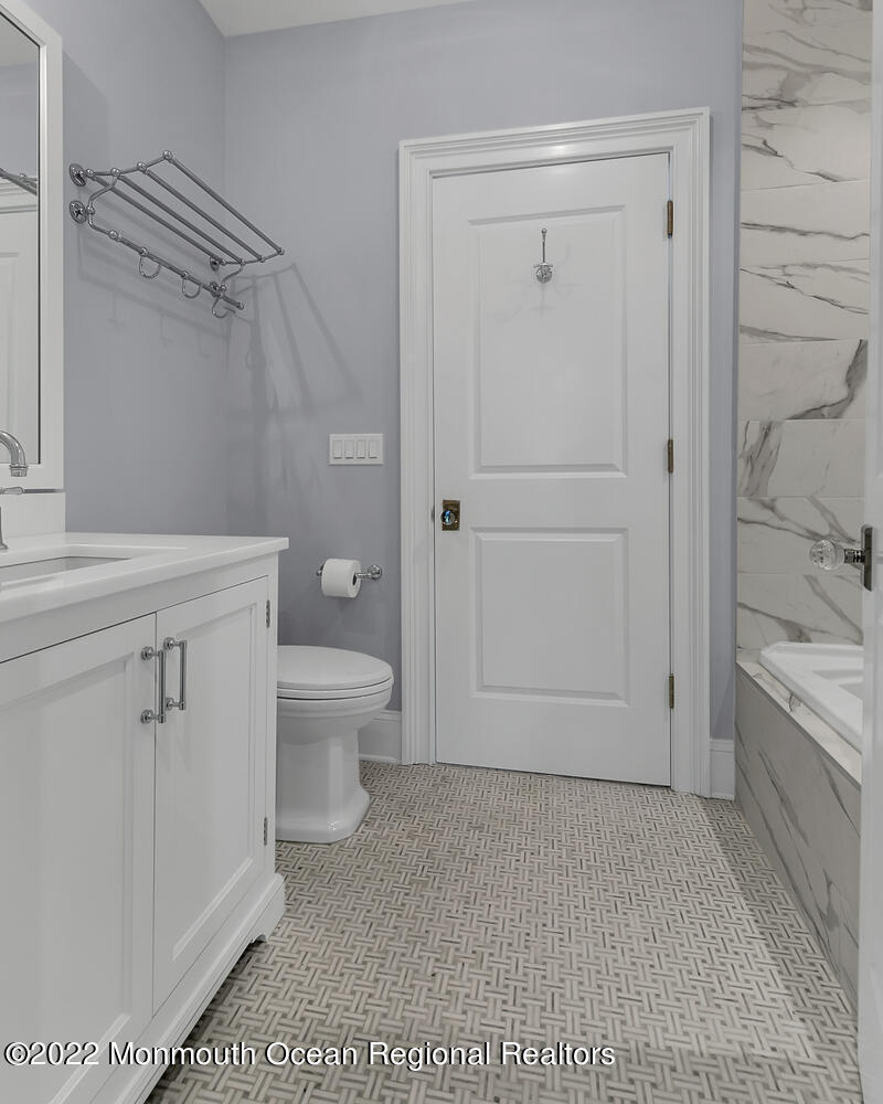 83 Rumson Road Rumson, NJ 07760 - Photo 36 of 56 a bathroom with a granite countertop sink a toilet and shower