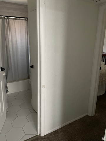 857 27th Street Ogden, UT 84403 - Photo 11 of 20 Bathroom featuring white hexagonal floor tiles, a white bathtub, and light grey wall tiles