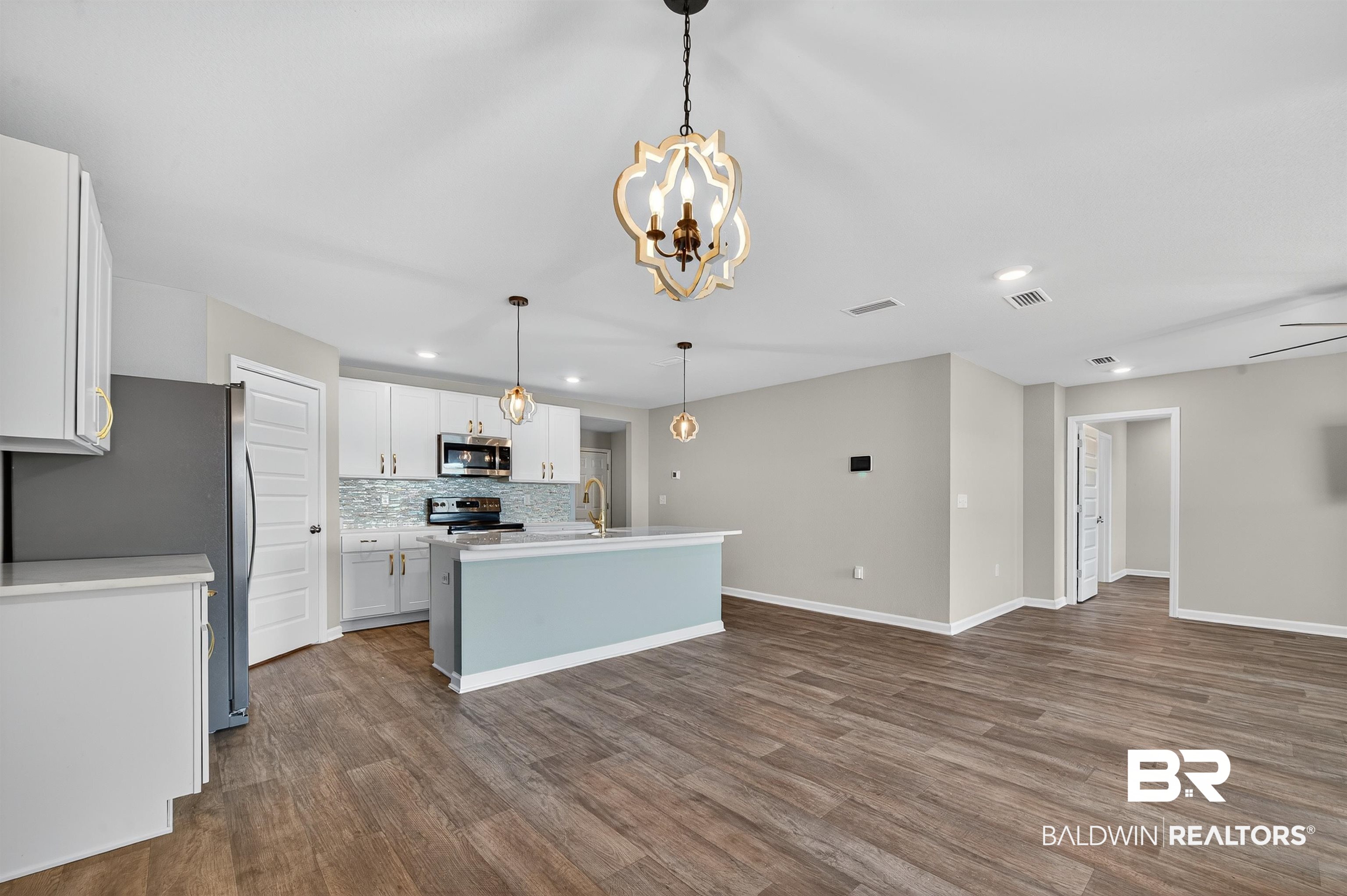7429 Brompton Drive Foley, AL 36535 - Photo 10 of 50 Kitchen with white cabinetry, decorative light fixtures, appliances with stainless steel finishes, dark wood-style floors, and recessed lighting