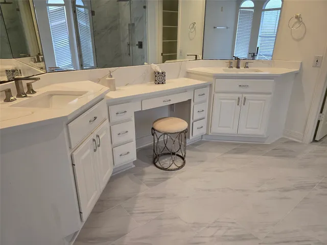 a spacious bathroom with a granite countertop sink a toilet and a mirror