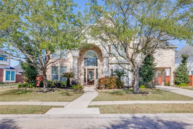 a living room with furniture a fireplace and a chandelier