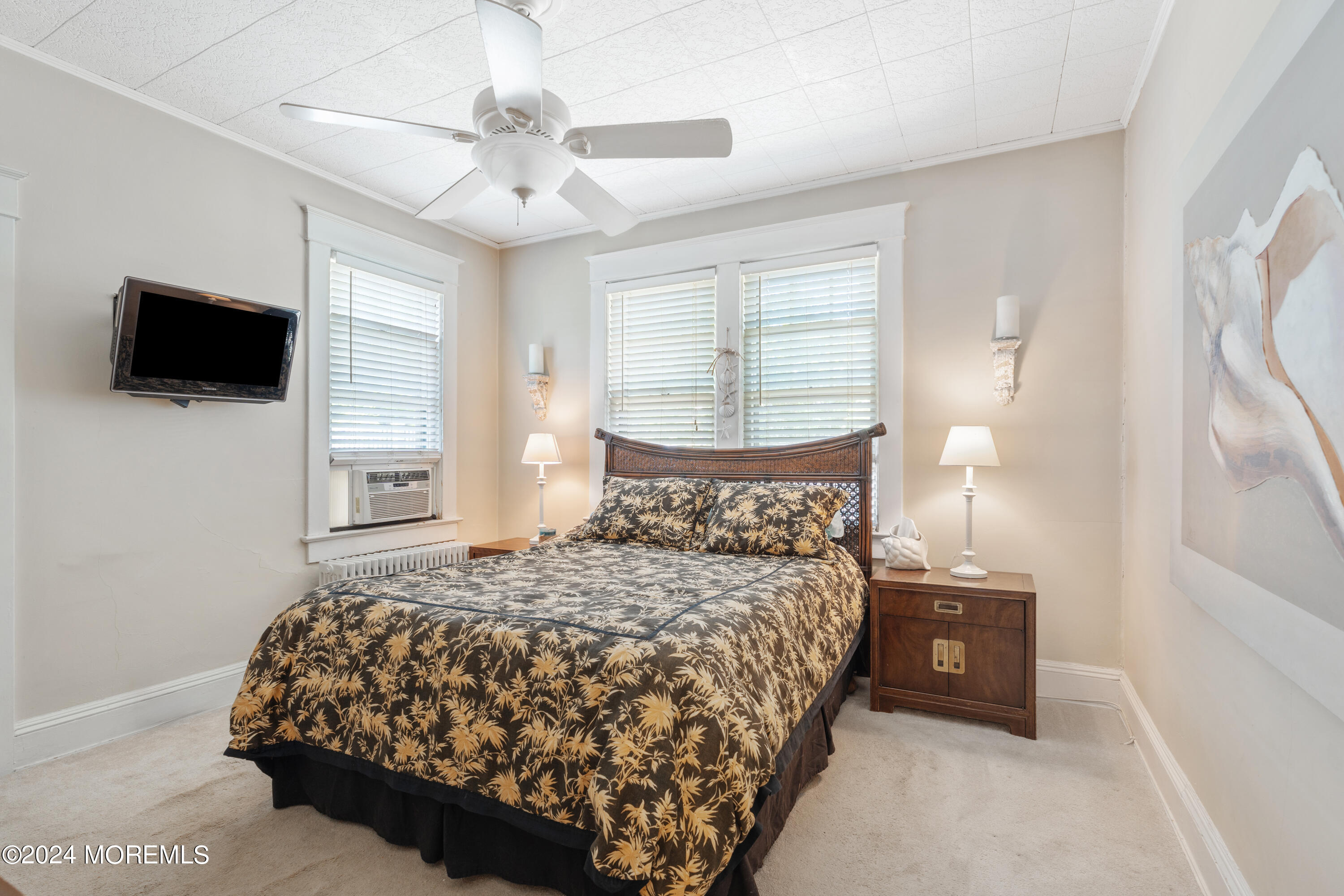 198 Pinckney Road Little Silver, NJ 07739 - Photo 8 of 20 a bedroom with a bed a mirror and a flat screen tv