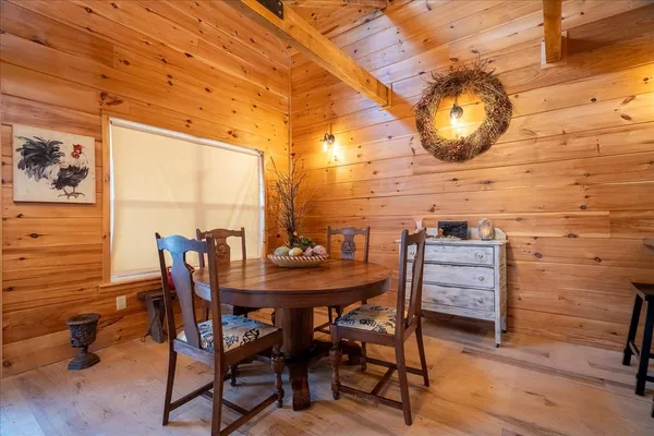 a view of a dining room with furniture and wooden floor