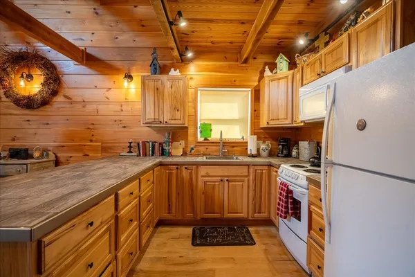 a kitchen with stainless steel appliances granite countertop a sink and cabinets